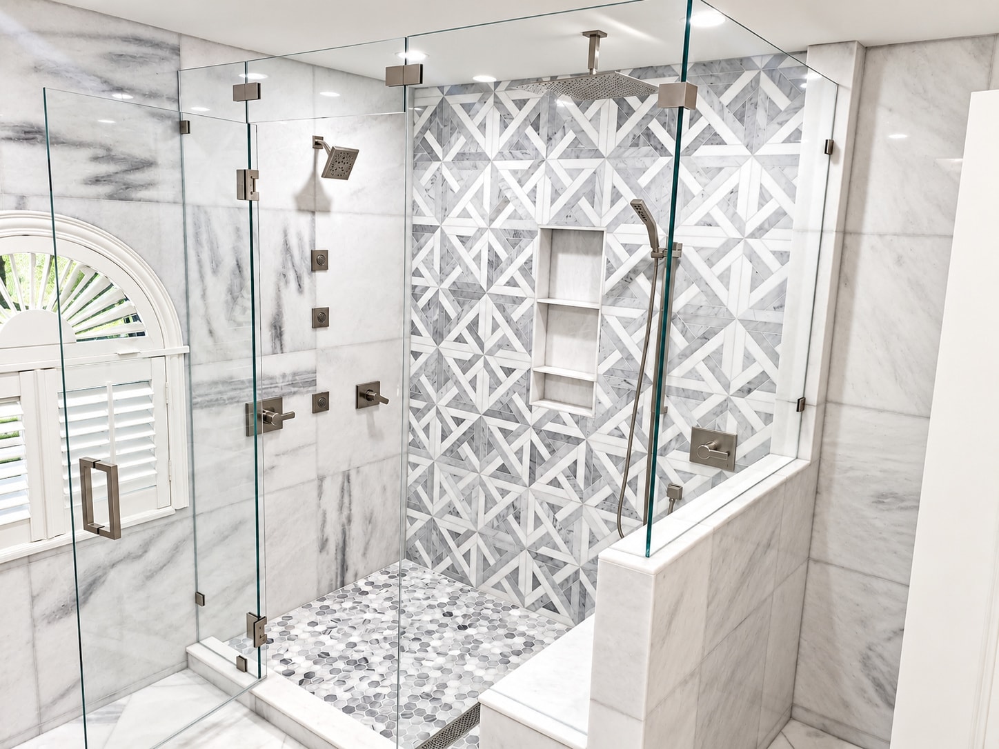 Modern marble walk-in shower with geometric tile