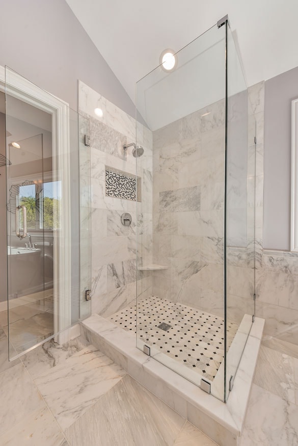 Modern marble bathroom with glass shower enclosure