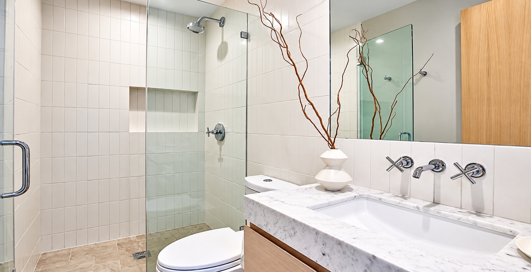 Modern bathroom with marble countertop and glass