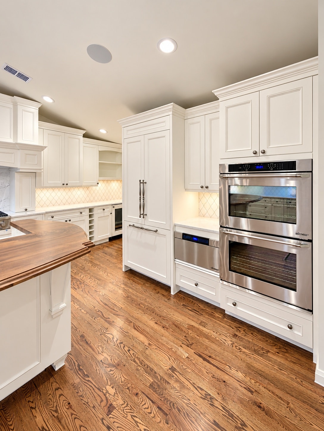 Modern white kitchen with stainless steel appliances