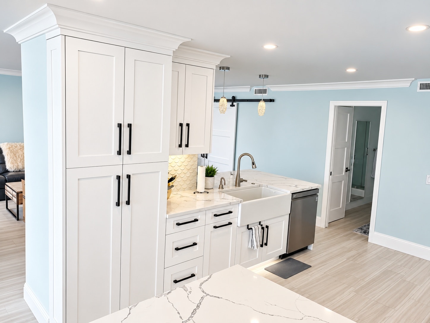 White shaker kitchen with farmhouse sink and pendant lights