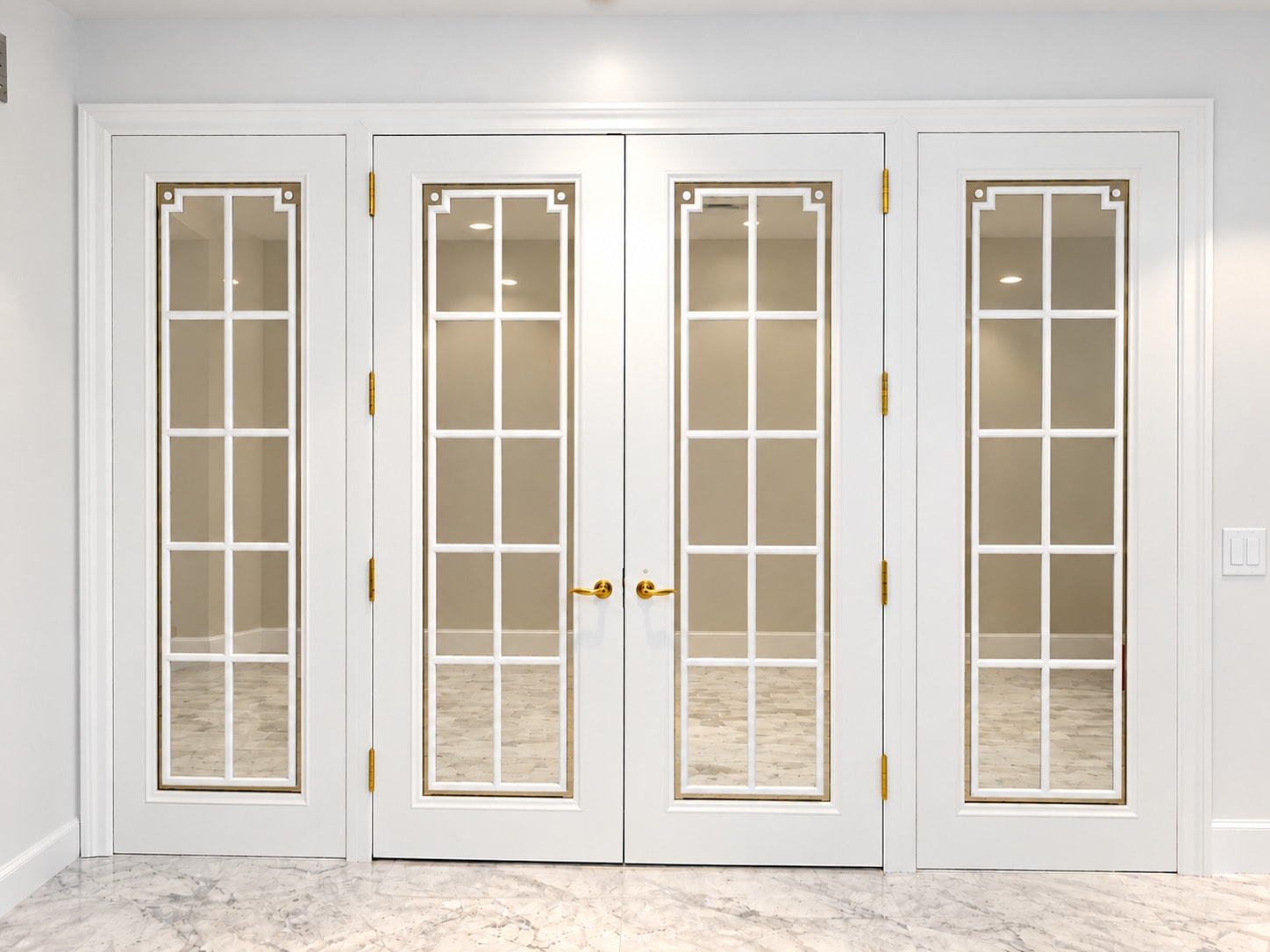White French doors with gold hardware and glass panes